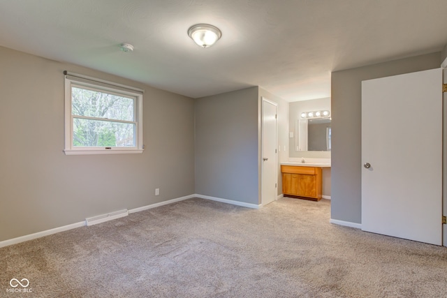 2205 Lafayette Rd, Crawfordsville, IN 47933 - unfurnished bedroom featuring connected bathroom, light carpet, visible vents, and baseboards