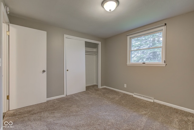 2205 Lafayette Rd, Crawfordsville, IN 47933 - unfurnished bedroom featuring a closet, carpet, visible vents, and baseboards