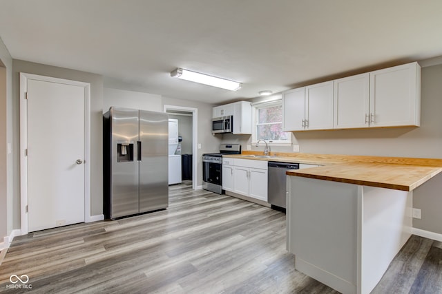 2205 Lafayette Rd, Crawfordsville, IN 47933 - kitchen with a sink, light wood-type flooring, butcher block counters, stainless steel appliances, and white cabinetry
