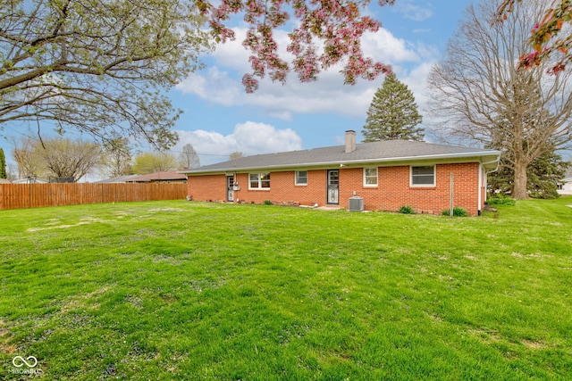 2205 Lafayette Rd, Crawfordsville, IN 47933 - back of property with central AC unit, a chimney, fence, a yard, and brick siding