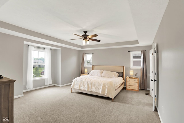 16491 Wheatley Ct, Fishers, IN 46040 - bedroom with a raised ceiling, light colored carpet, baseboards, and a ceiling fan