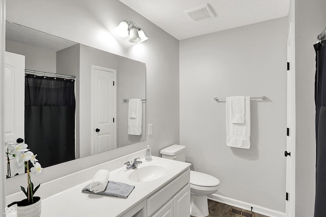 16491 Wheatley Ct, Fishers, IN 46040 - bathroom with toilet, vanity, wood finished floors, baseboards, and curtained shower