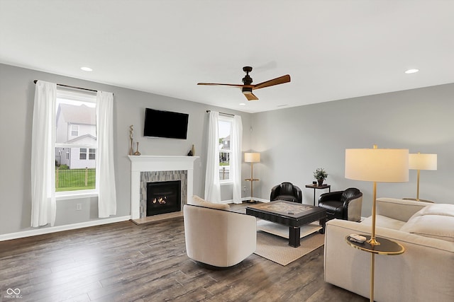 16491 Wheatley Ct, Fishers, IN 46040 - living area with dark wood-type flooring, a tiled fireplace, ceiling fan, recessed lighting, and baseboards