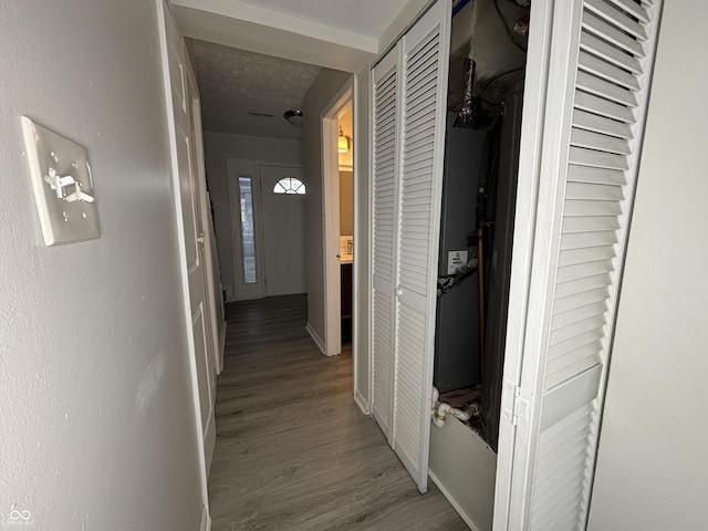 hall featuring baseboards and wood finished floors