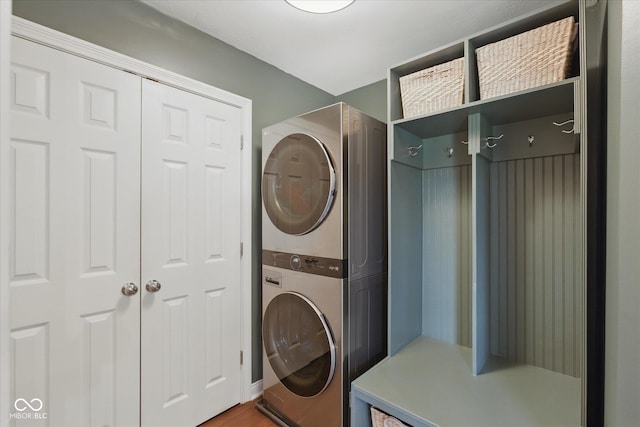 laundry room with stacked washer / drying machine and laundry area