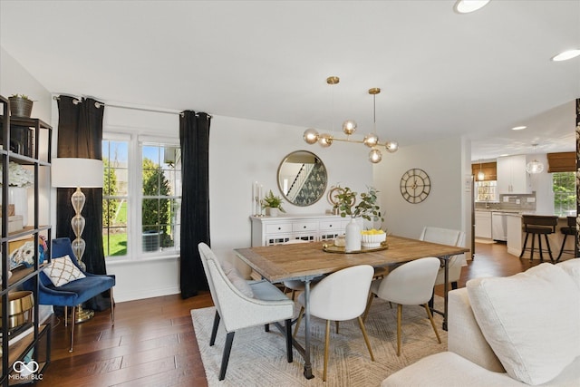 dining area featuring baseboards, recessed lighting, wood finished floors, and a chandelier