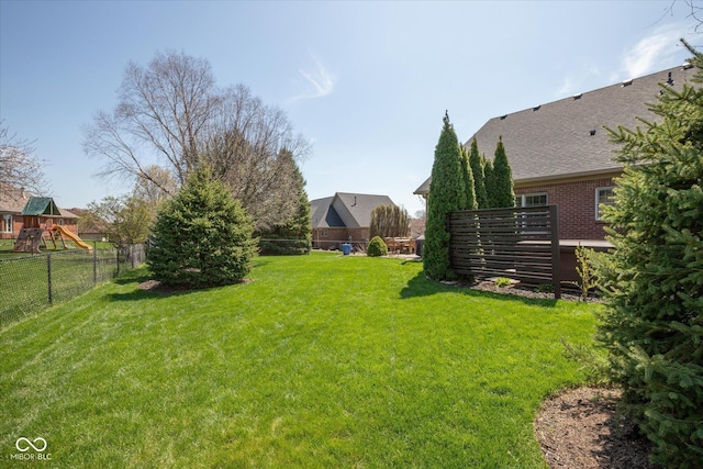 view of yard featuring a fenced backyard and a playground