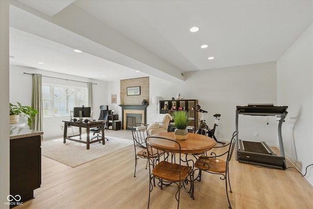dining area with recessed lighting, baseboards, a fireplace, and light wood-type flooring