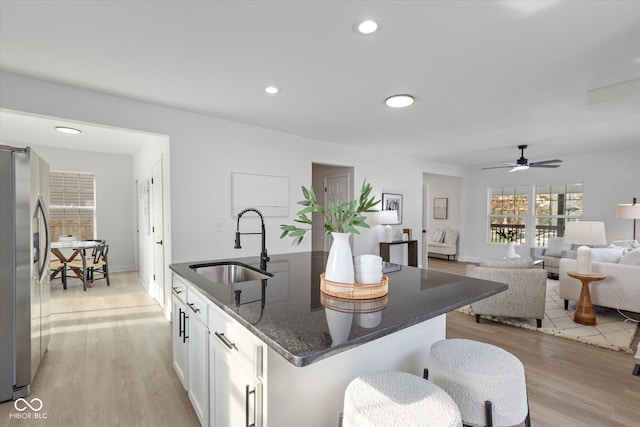 625 N Parker Ave, Indianapolis, IN 46201 - kitchen with stainless steel refrigerator with ice dispenser, a sink, an island with sink, light wood-type flooring, and recessed lighting