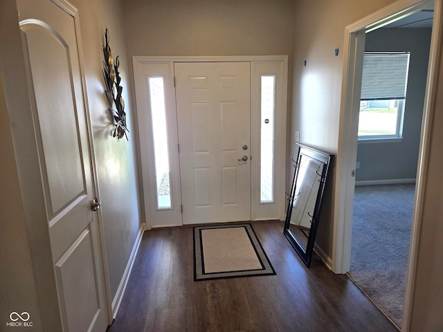 foyer with baseboards and dark wood-style flooring
