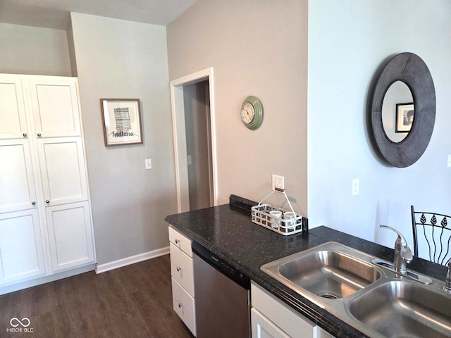 kitchen featuring white cabinets, a sink, dark wood-style flooring, baseboards, and dishwasher