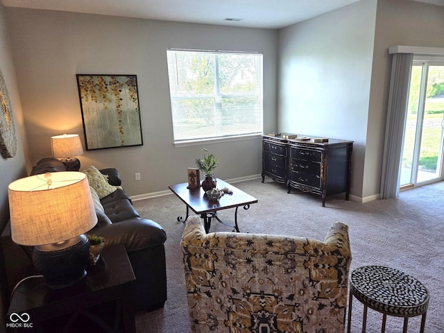 carpeted living room with baseboards