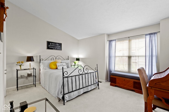 carpeted bedroom with baseboards and lofted ceiling
