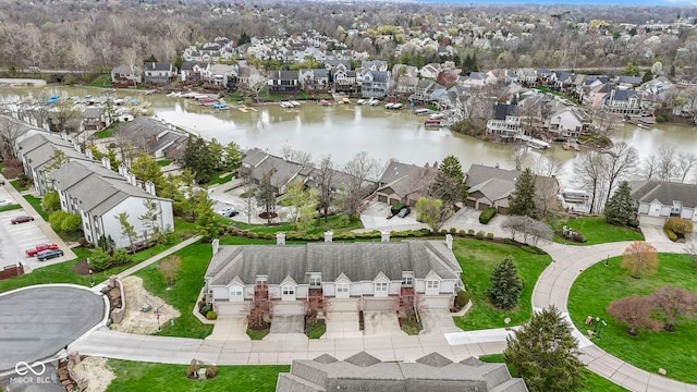 drone / aerial view with a residential view and a water view