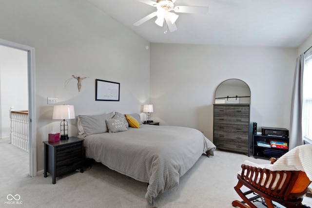 carpeted bedroom with ceiling fan and vaulted ceiling