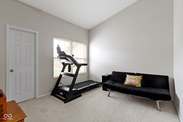 exercise area with lofted ceiling, carpet, and baseboards