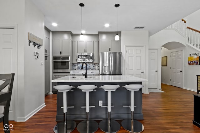 kitchen with tasteful backsplash, visible vents, baseboards, appliances with stainless steel finishes, and dark wood finished floors