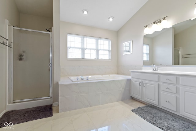 bathroom featuring a garden tub, a shower stall, and vanity