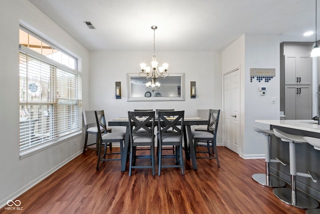dining space featuring an inviting chandelier, visible vents, dark wood-style floors, and baseboards