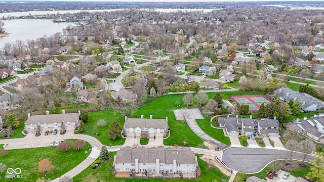 birds eye view of property with a water view and a residential view