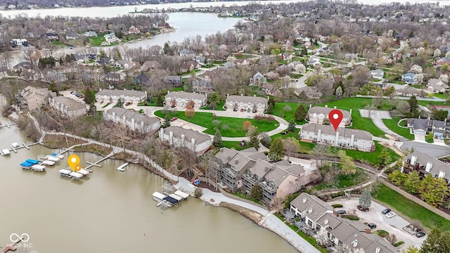 birds eye view of property with a water view and a residential view