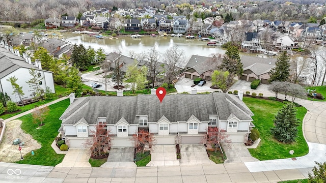 birds eye view of property with a water view and a residential view