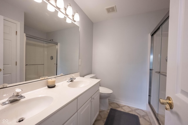 full bath with visible vents, a sink, a stall shower, and toilet