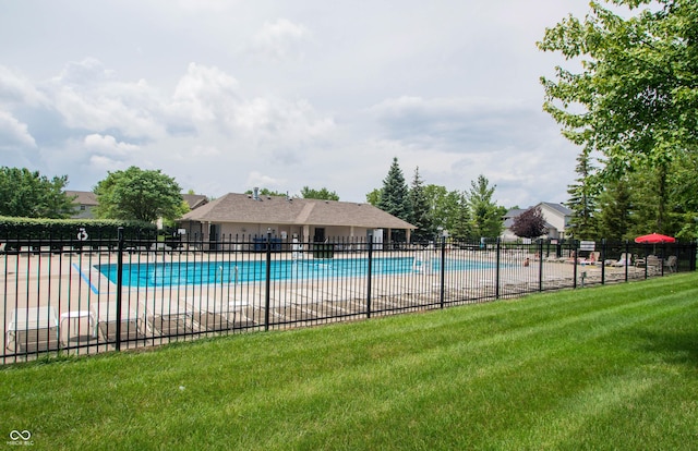 pool with a lawn and fence