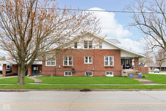view of side of home featuring brick siding and a lawn