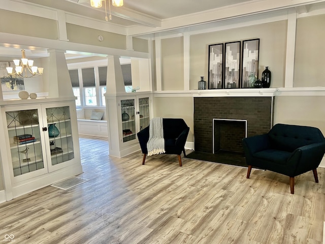 4205 Rookwood Ave, Indianapolis, IN 46208 - sitting room with a fireplace, a notable chandelier, beamed ceiling, and wood finished floors