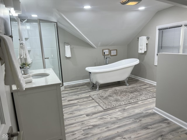4205 Rookwood Ave, Indianapolis, IN 46208 - bathroom featuring baseboards, a freestanding tub, a stall shower, and wood finished floors