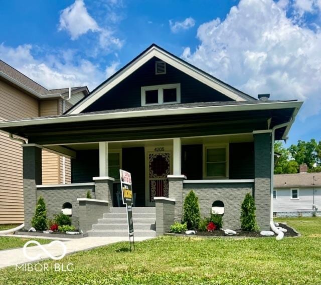 4205 Rookwood Ave, Indianapolis, IN 46208 - view of front of property featuring a porch, stone siding, and a front lawn