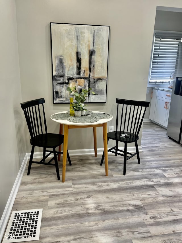 4205 Rookwood Ave, Indianapolis, IN 46208 - dining room featuring light wood finished floors, baseboards, and visible vents