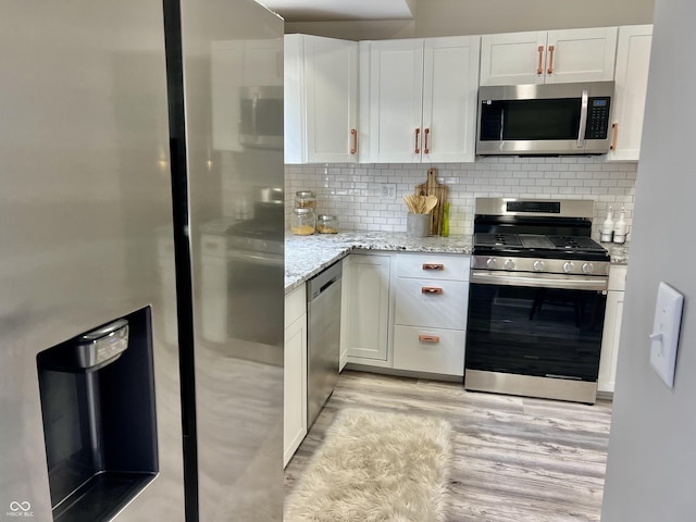 4205 Rookwood Ave, Indianapolis, IN 46208 - kitchen featuring tasteful backsplash, light stone counters, white cabinetry, and stainless steel appliances