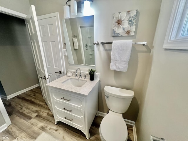 4205 Rookwood Ave, Indianapolis, IN 46208 - bathroom featuring vanity, baseboards, toilet, and wood finished floors