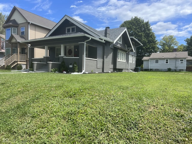 4205 Rookwood Ave, Indianapolis, IN 46208 - rear view of house with central air condition unit, covered porch, and a lawn