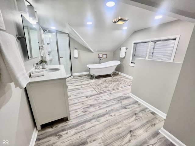 4205 Rookwood Ave, Indianapolis, IN 46208 - full bath with baseboards, vanity, vaulted ceiling, wood finished floors, and a stall shower