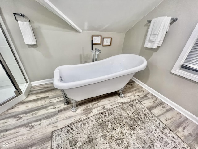 4205 Rookwood Ave, Indianapolis, IN 46208 - bathroom with a freestanding tub, baseboards, a stall shower, and wood finished floors