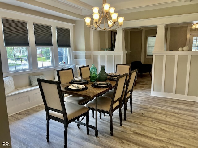 4205 Rookwood Ave, Indianapolis, IN 46208 - dining space featuring a chandelier, a decorative wall, and light wood-style flooring