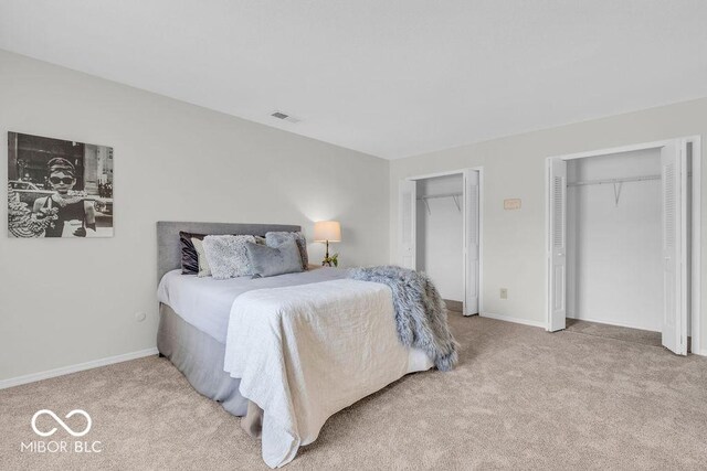 1632 Queensbridge Sq Unit 7, Indianapolis, IN 46219 - carpeted bedroom featuring multiple closets and baseboards