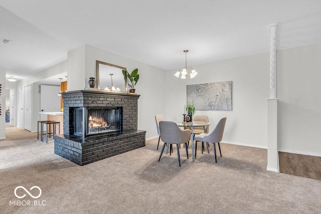 1632 Queensbridge Sq Unit 7, Indianapolis, IN 46219 - dining area featuring carpet flooring, a brick fireplace, baseboards, and a chandelier