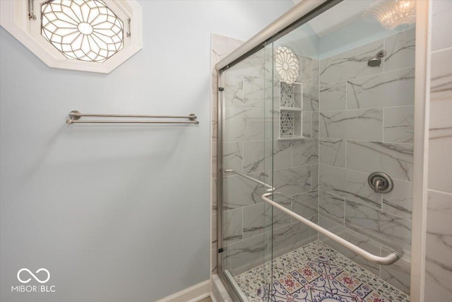 bathroom with a marble finish shower