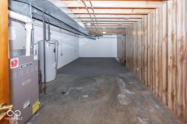 basement featuring heating unit and electric water heater