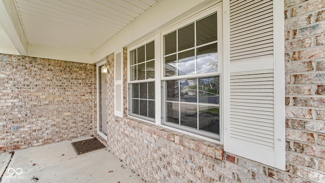 exterior space featuring a porch and brick siding