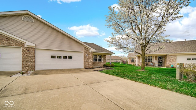 view of home's exterior featuring concrete driveway, brick siding, and a lawn