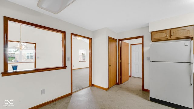 interior space featuring baseboards, an inviting chandelier, and light floors