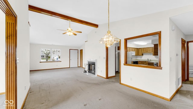 unfurnished living room featuring baseboards, light colored carpet, vaulted ceiling with beams, and ceiling fan with notable chandelier