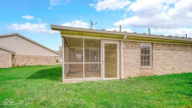 back of house with a yard and a sunroom