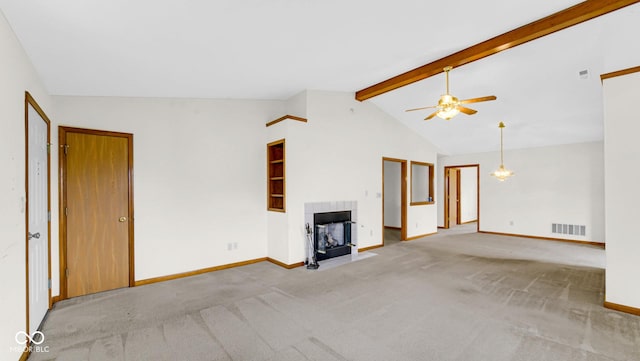 unfurnished living room with visible vents, ceiling fan, carpet, a fireplace, and vaulted ceiling with beams