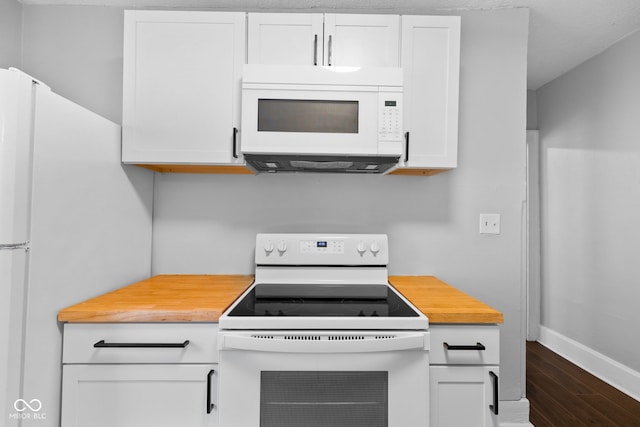 kitchen with dark wood finished floors, white appliances, white cabinetry, wood counters, and baseboards